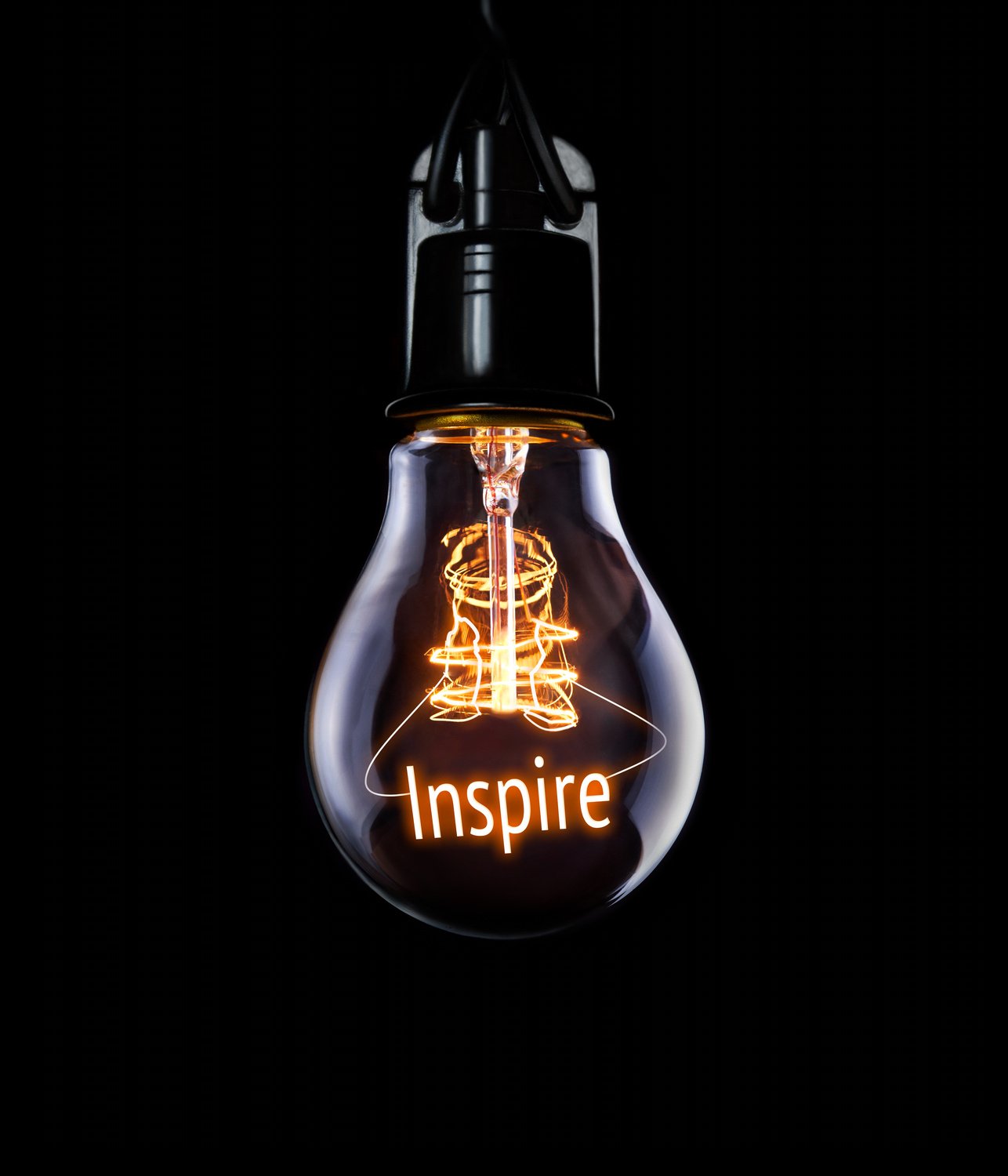 Hanging lightbulb with glowing Inspire concept.